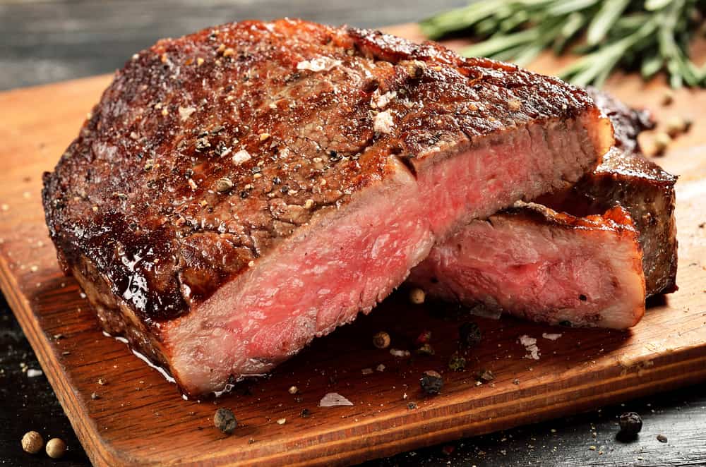 red liquid on meat steak